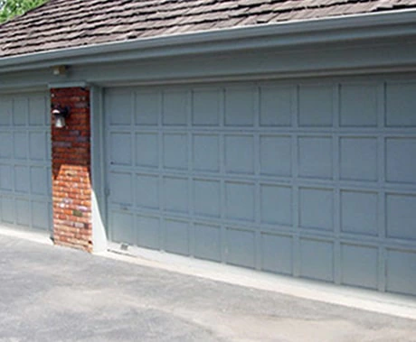Grey paneled garage door before the work