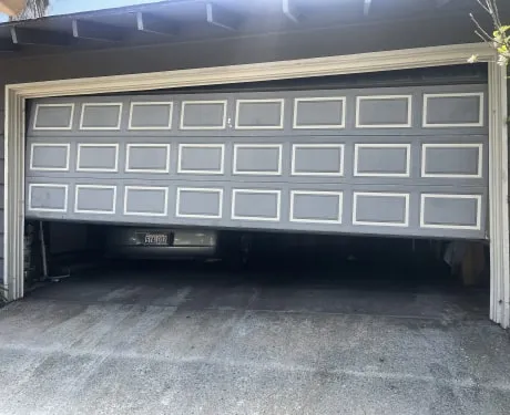 Grey garage door before the work
