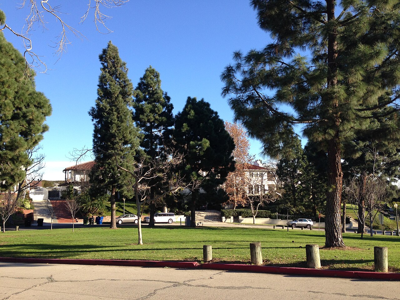 Club Circle Park in Cheviot Hills with lawns, trees and nearby homes.
