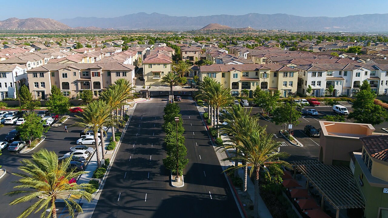 Palm-lined approach to multi-story residential buildings.
