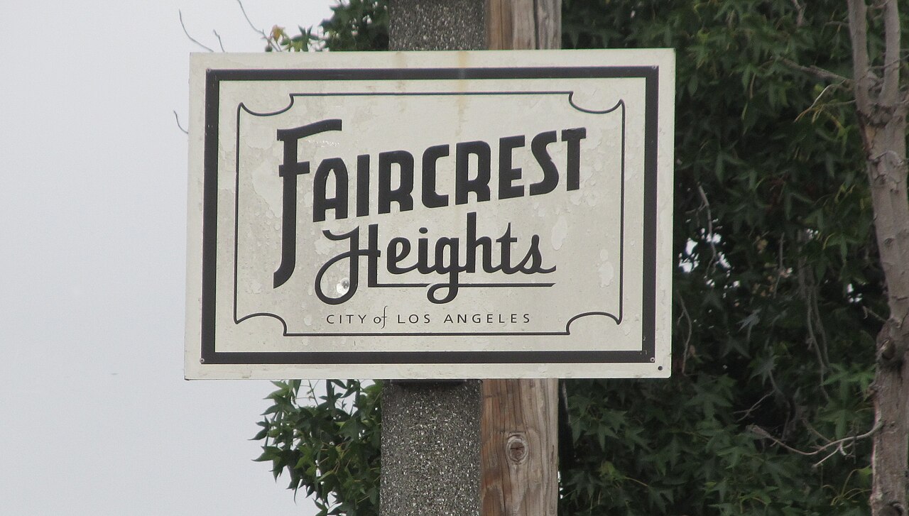Faircrest Heights neighborhood sign among trees.