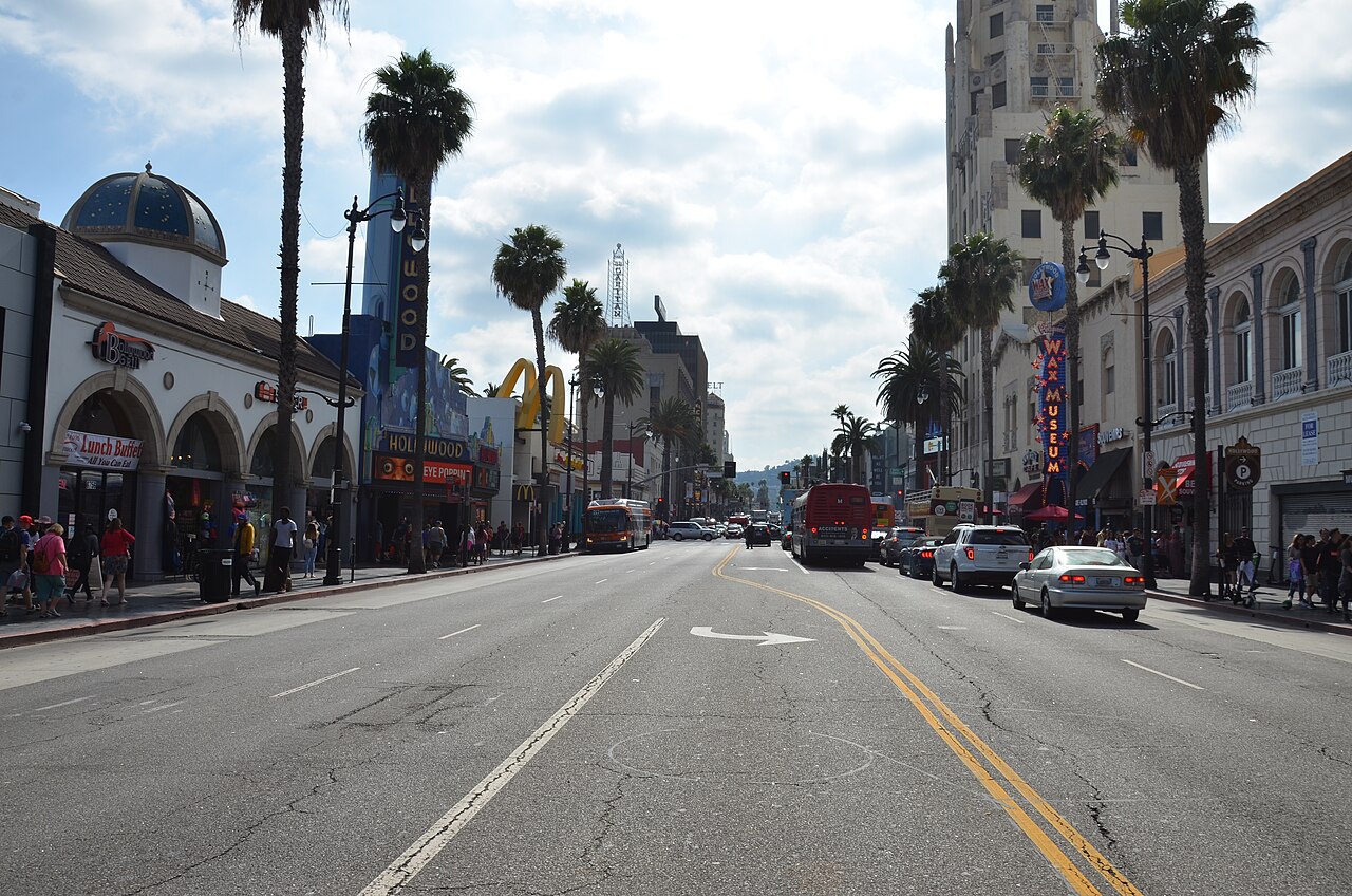Hollywood Boulevard streetscape with theater buildings and palms.