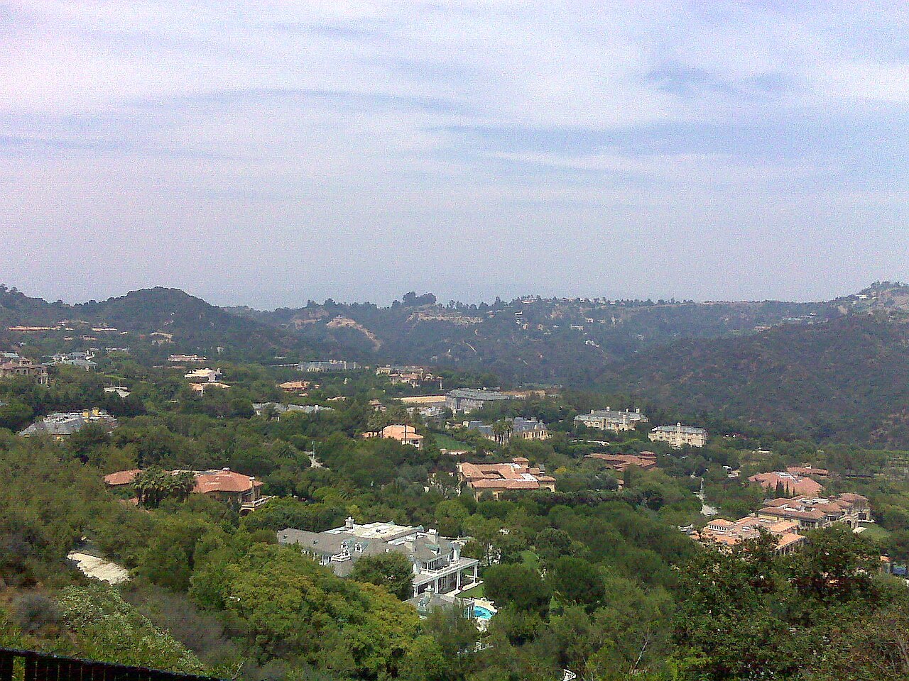 Hillside residential panorama with greenery and homes, consistent with North Beverly Park overlook.