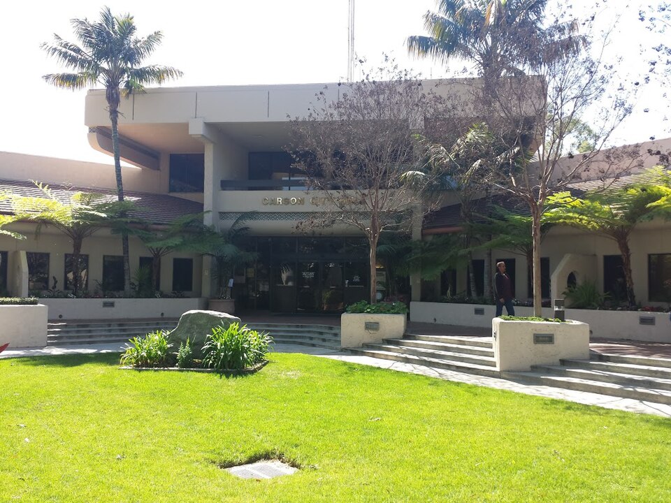 Carson City Hall exterior with lawn, palms and landscaped entry.