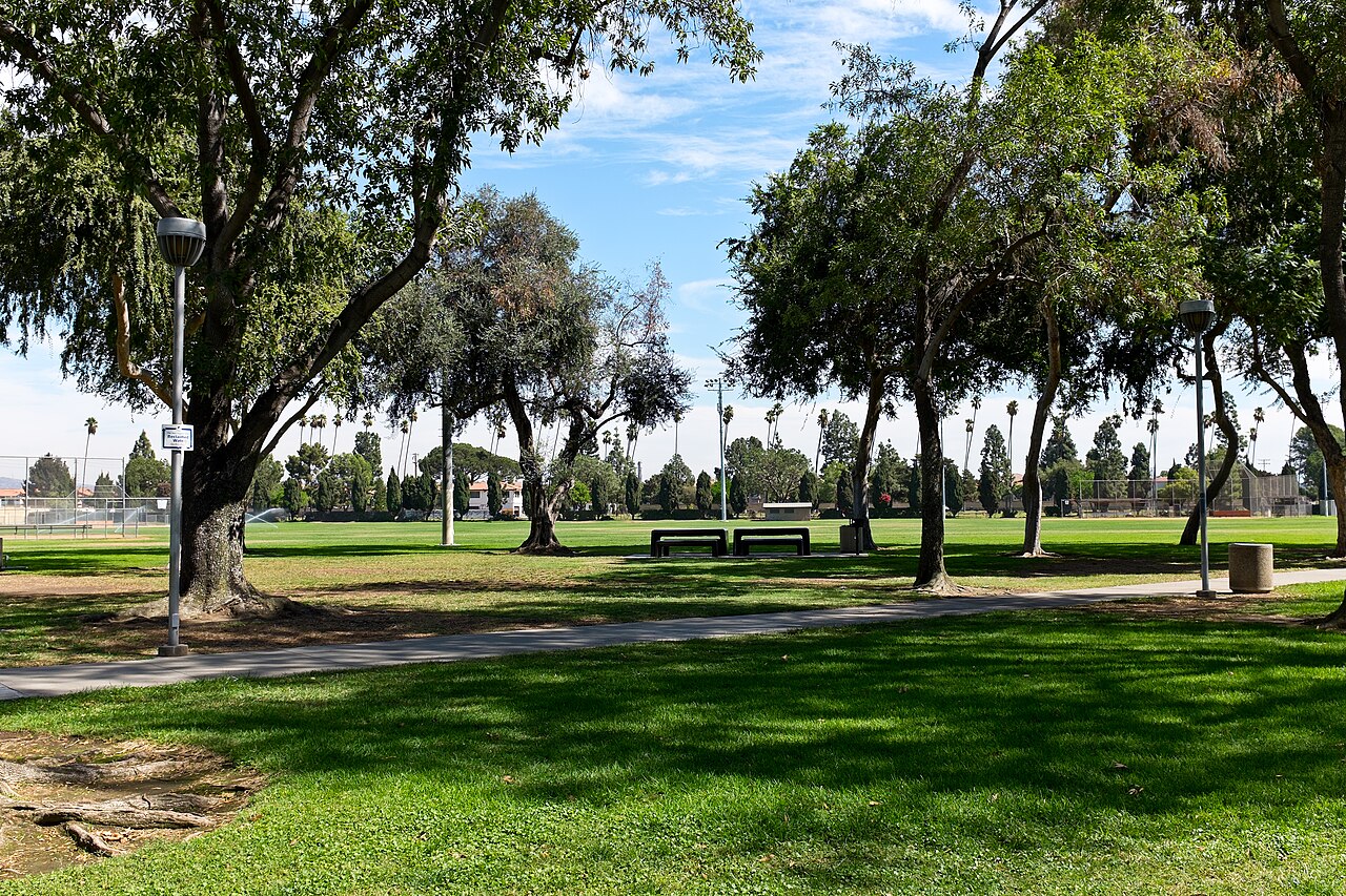 Open lawn and trees at Little Lake Park in Santa Fe Springs.