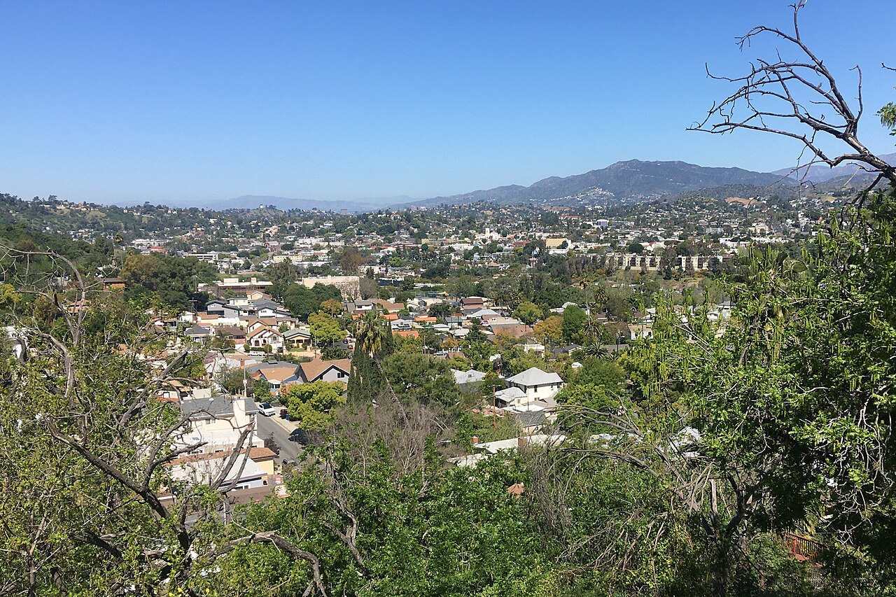 Homes and tree-lined streets spread across a valley.